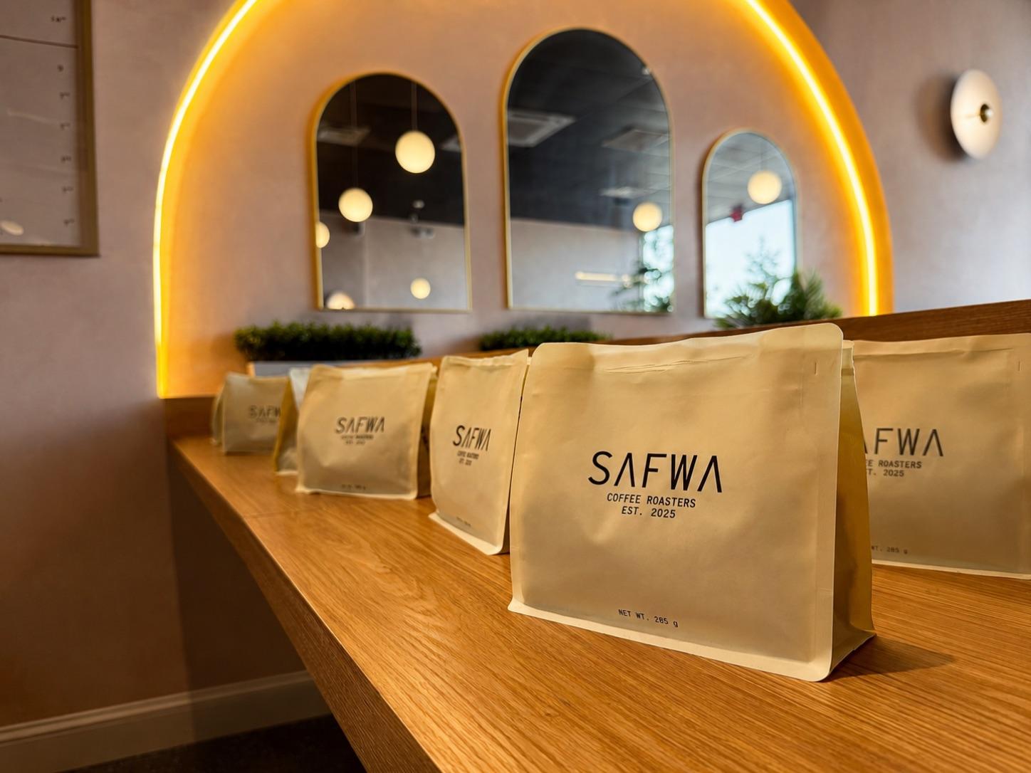 Bags of Safwa Coffee Roasters beans on the counter at the Westbury cafe